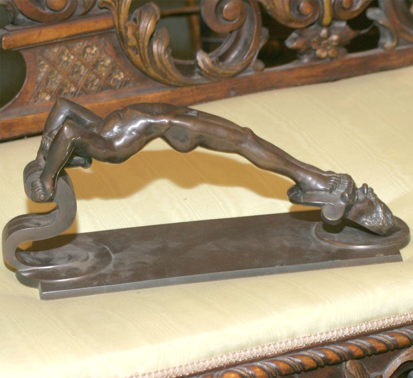 A ART DECO DOOR KNOCKER IN THE FORM OF A MAIL NUDE.
