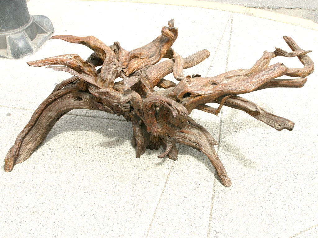 Configured pieces of driftwood forming a large coffee table base