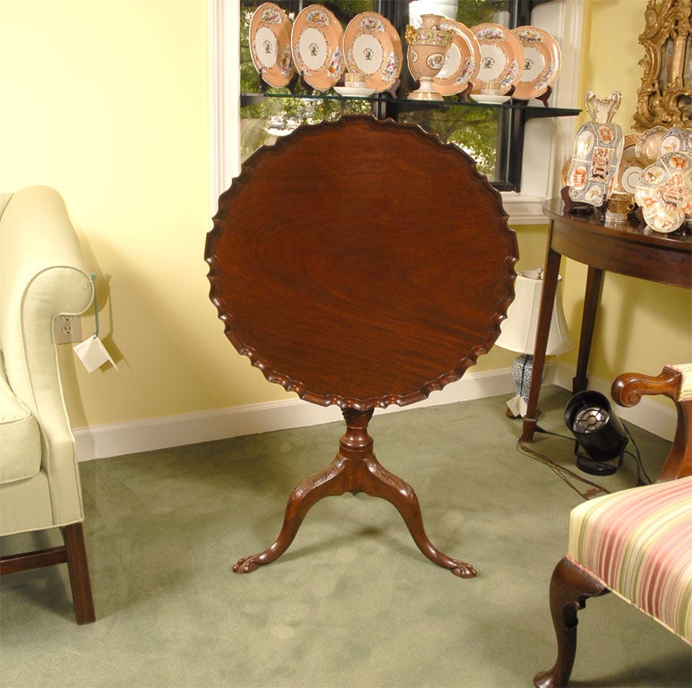 A fine Mahogany Dessert Table supported by a tri-pod base and central turned pedestal. The edge of the table is a raised, scalloped design called 