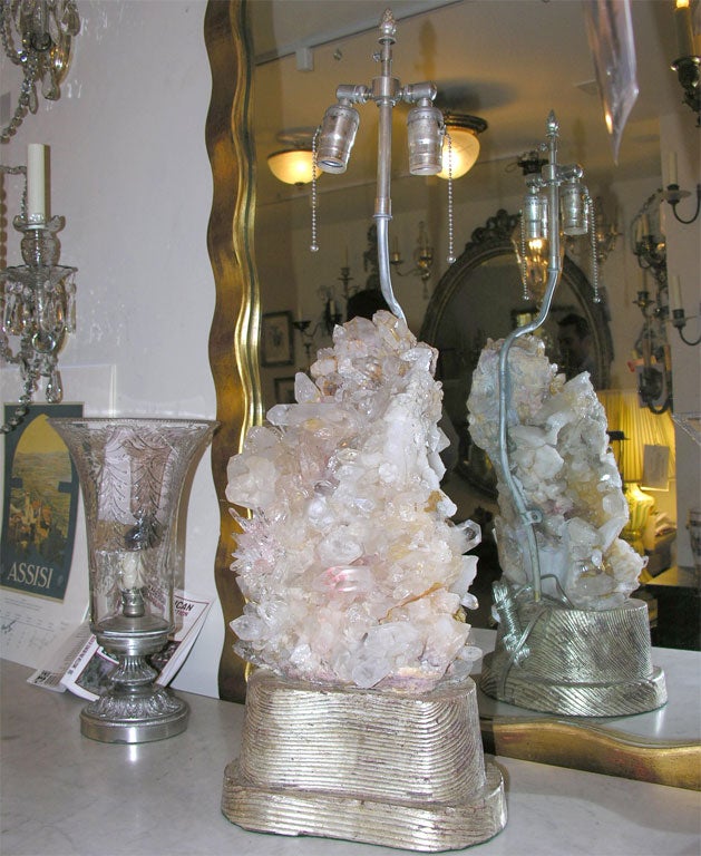 A Carol Stupell table lamp in the form of a section of quartz crystal on a hand carved, silvered driftwood base. Circa 1950.