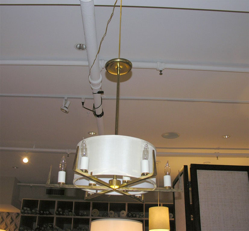 9 Light Brass Chandelier with Silk Drum Shade. 6 candleabras around the outside of shade and 3 inside.