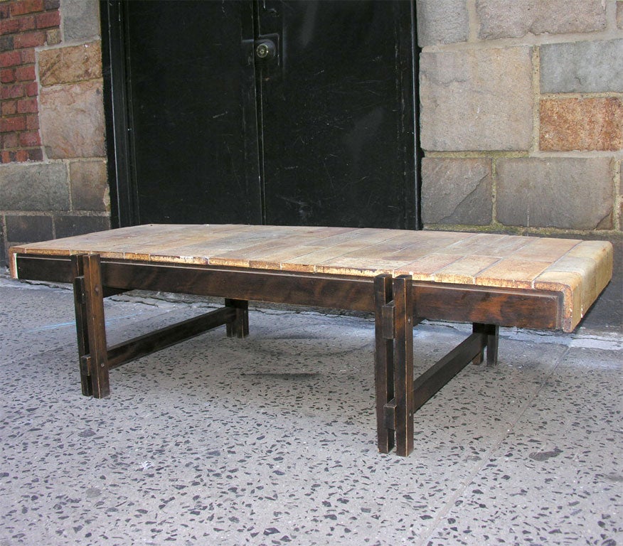 A coffee and cocktail table by Roger Capron, produced circa 1950s, with architectural base, crafted of wood with ceramic tile top. Markings include signature [R. Capron] to the top.