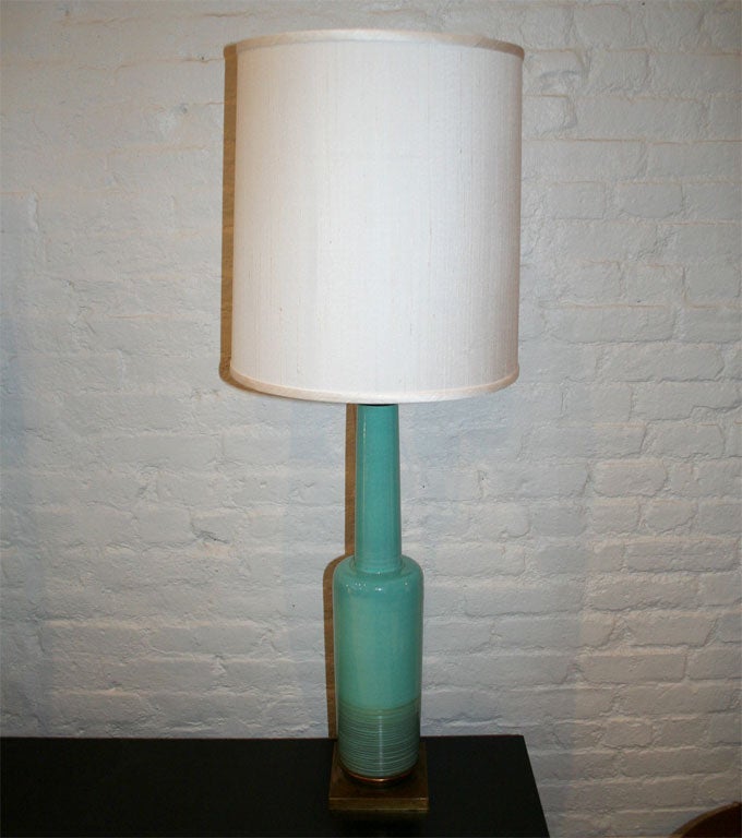 Beautiful pair of tall ceramic lamps with a brass base and stem, manufactured by Stiffel in a vivid turquoise blue.