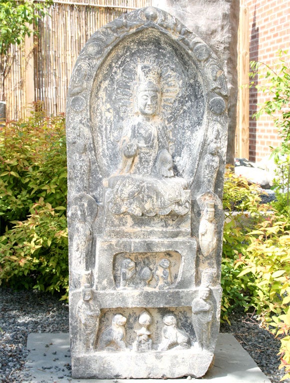 A sizeable Chinese marker featuring the Seated Buddha of the Present, flanked by Luohans, Bodhisattvas, and Lokapalas.  The reverse side depicts a seated Buddha of the Future under a ginko tree.