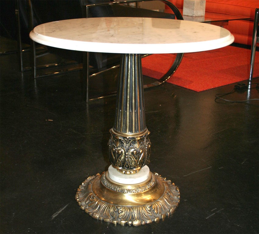 Italian marble and brass table. The tabletop is Carrara marble. The base is brass with one marble disk.