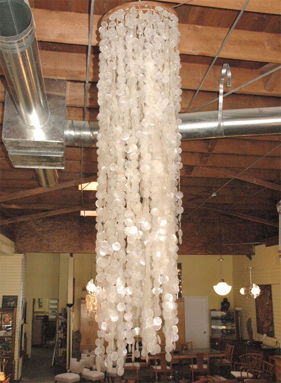 capiz shells hung by thread from wood canopy