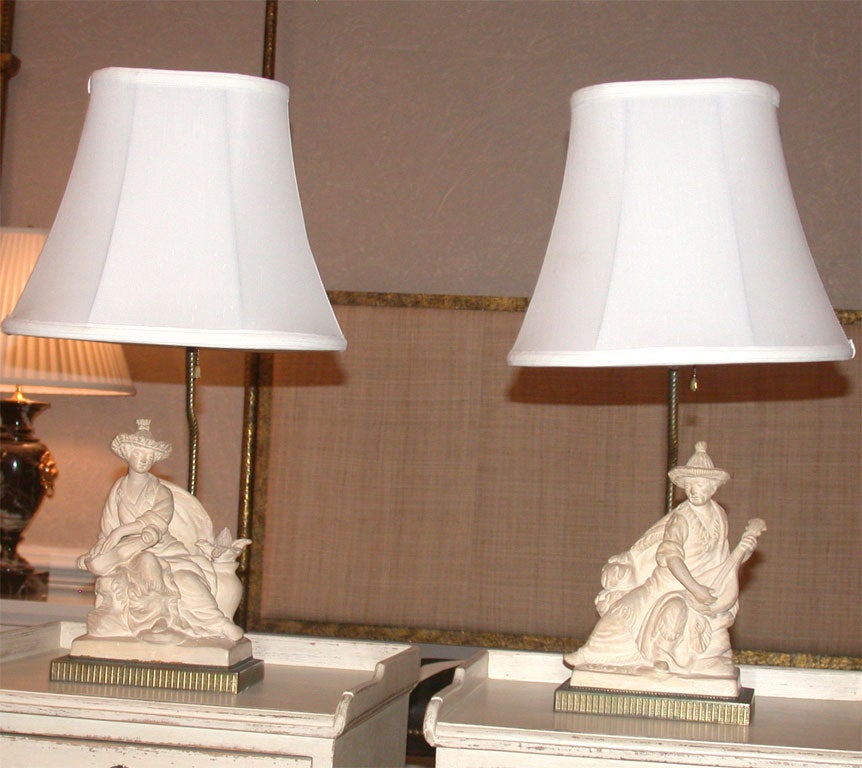 Pair of Chinese chalkware figural statues mounted as lamps, circa 1930. The shades are included with the price of the lamps.