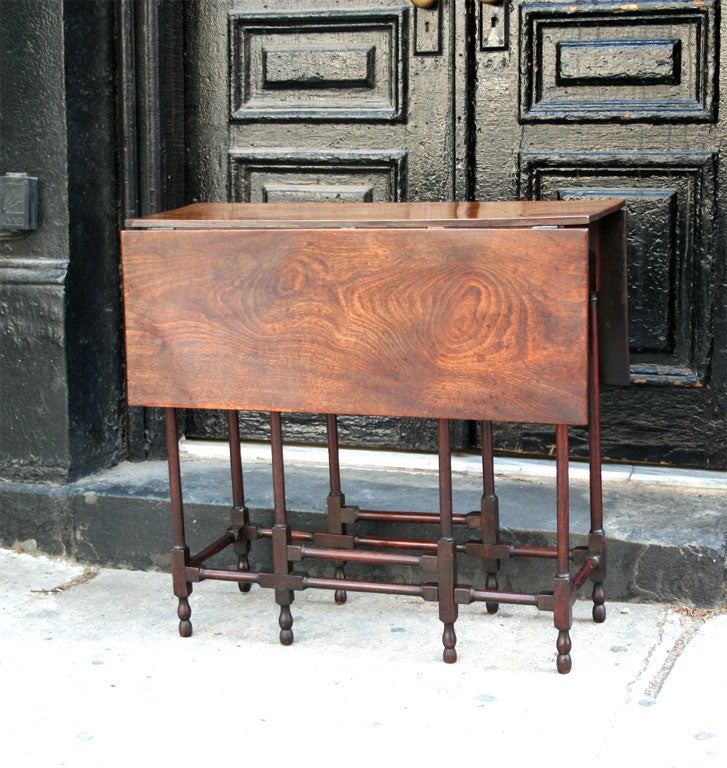 An elegant English 18th C diminutive spider leg table in elm. Wonderful form and color.