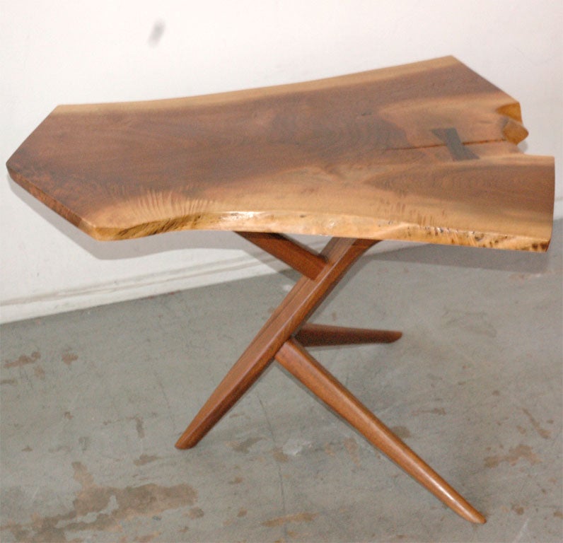 The single-slab top of this gorgeous table features three free edges, a rosewood butterfly, and the highly figured grain that is characteristic of good English walnut. <br />
<br />
Signed with client name to underside: [Simon].<br />
<br