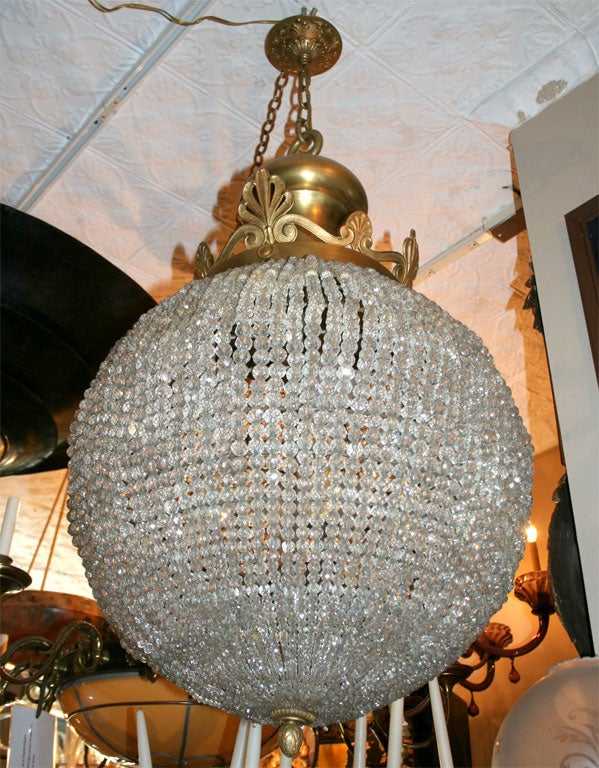 A neoclassic style turn of the century, French gilt bronze crystals lantern with crystal beads. 
Measurements:
Height: 40