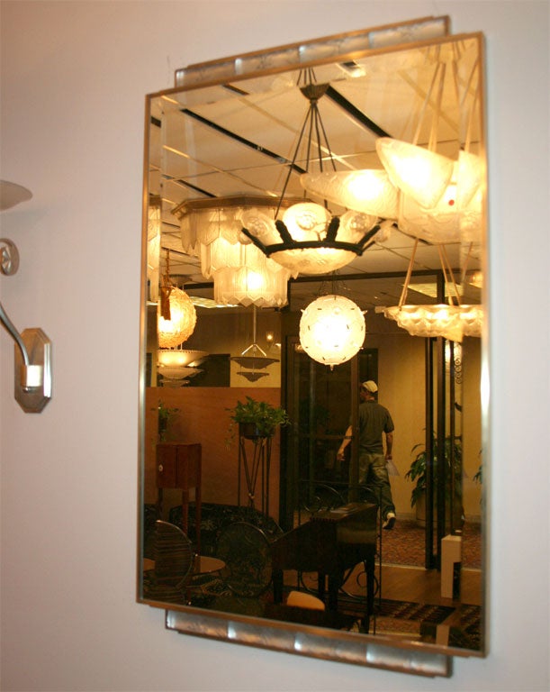 An Art Deco wall mirror decorated with eight Rene Lalique glass segments, design 