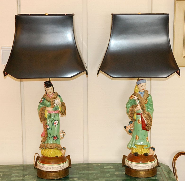 Newly assembled lamps with couture lampshades that are black with pink interior. These lamps give a low pink light.