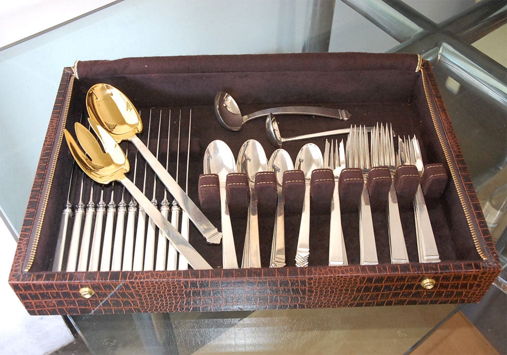 This is a Tiffany sterling silver flatware set, Hampton pattern and is a 5 pcs place setting for 12, plus 4 serving pcs, 2 large serving pcs with gold vermille at the end. The set is 12 knives, 12 large spoons,12 dessert spoons, 12 dinner forks, 12