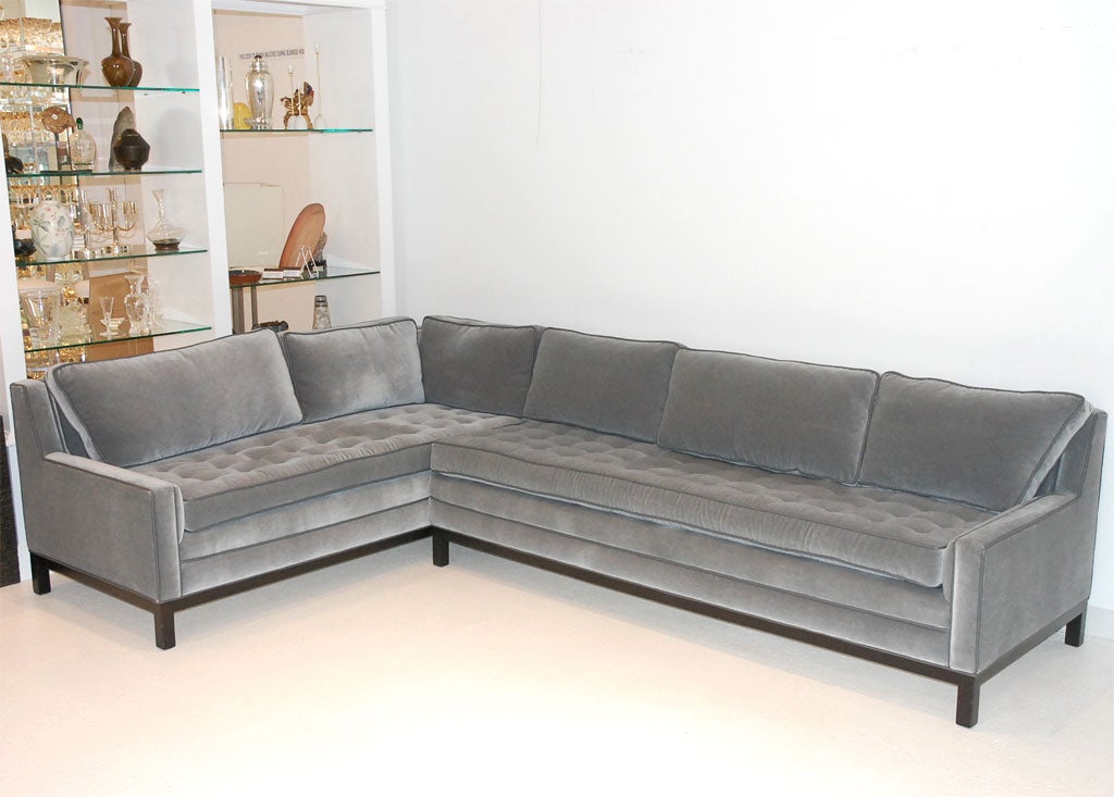 Stunning loose-cushion sectional sofa, recently reupholstered in a blue-grey mohair with grey leather piping and buttons.  With an ebonized wood frame, the sofa is made up of two sections- one section measuring 77