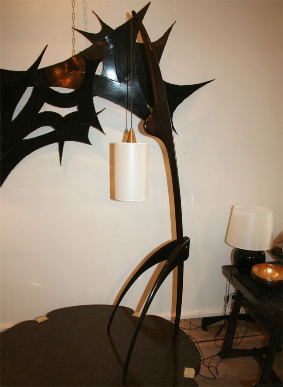 Carved mahogany floor lamps by Rispal. These iconic lamps have beautiful organic lines and a very ingenuous assembly.