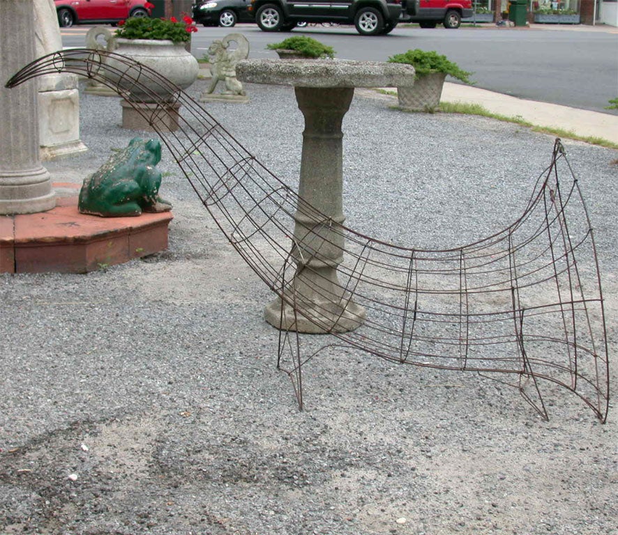 Wire cornucopia from a florist's shop in Rochester, New York. Big and bold.
Can be used indoors with self supporting wire feet. Grace and stylish utilitarian garden object in grand size.