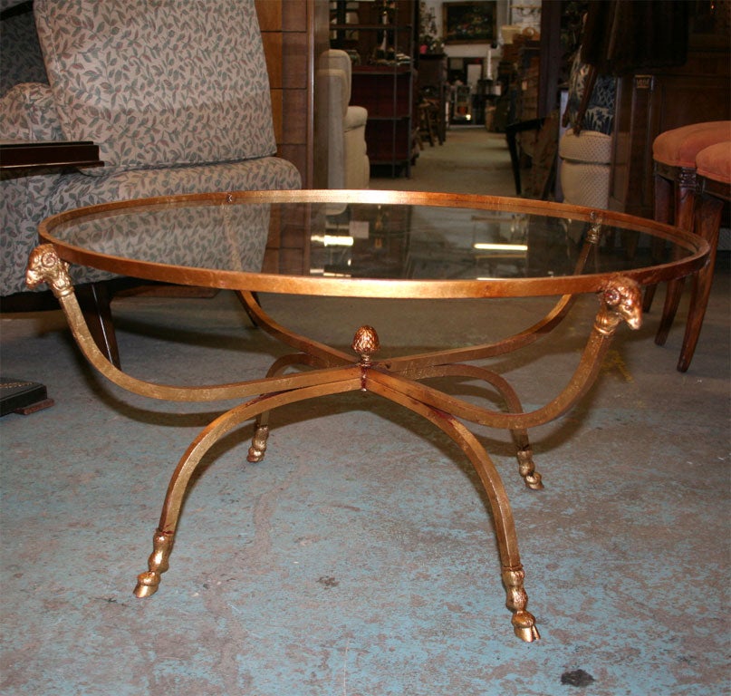 Gold Leaf Rams Head Table with hoof feet and glass insert top.