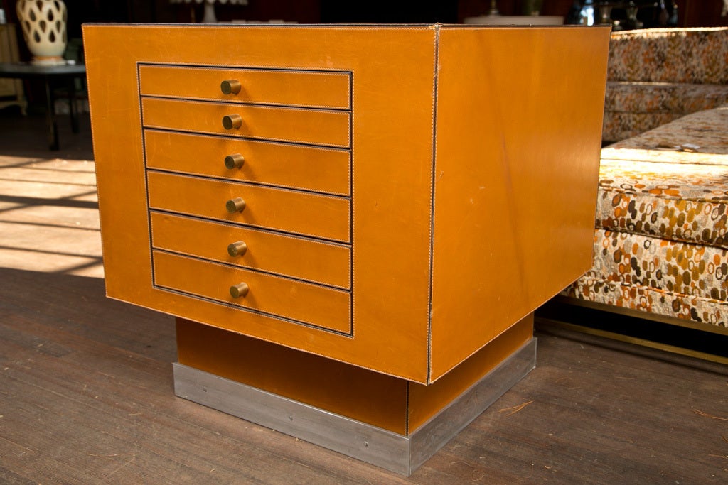 Delvaux is the leather shop equivalent of Hermes in Belgium. There are six drawers on one side and three drawers on the reverse side. The cabinet is finished in hand-stitched leather on all four sides and the top. The plinth base is hand-stitched