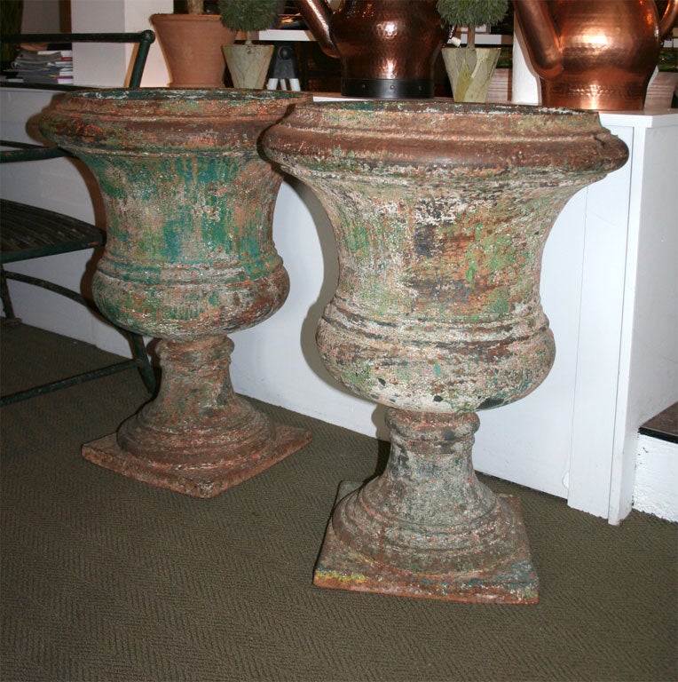 A pair of impressive iron urns in the Directoire style.