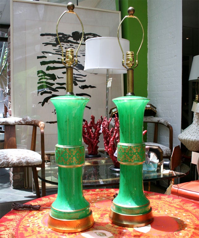 Incredible glass lamps, with bands of gold leaf acanthus design and gilt bases.