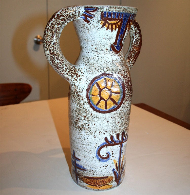 Vase of glazed ceramic with female form design, signed.
