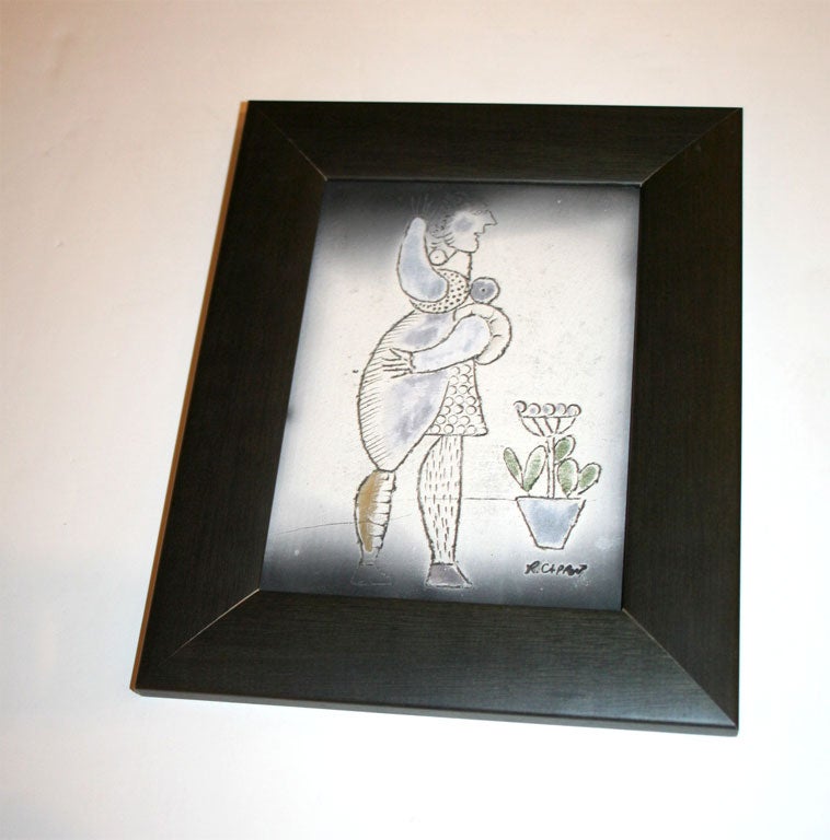 Framed ceramic plaque with woman and plant; signed lower right.