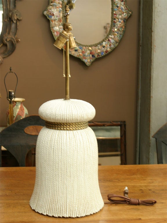 Here is an elegant ceramic tassel lamp with a gilded rope detail.