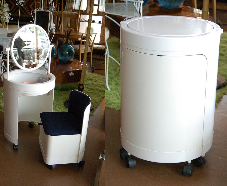 Clever acrylic vanity, mirror and stool on wheels that folds into itself. Has endless hidden storage.