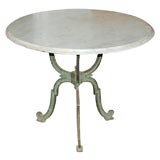 A patinated cast iron and marble gueridon / table