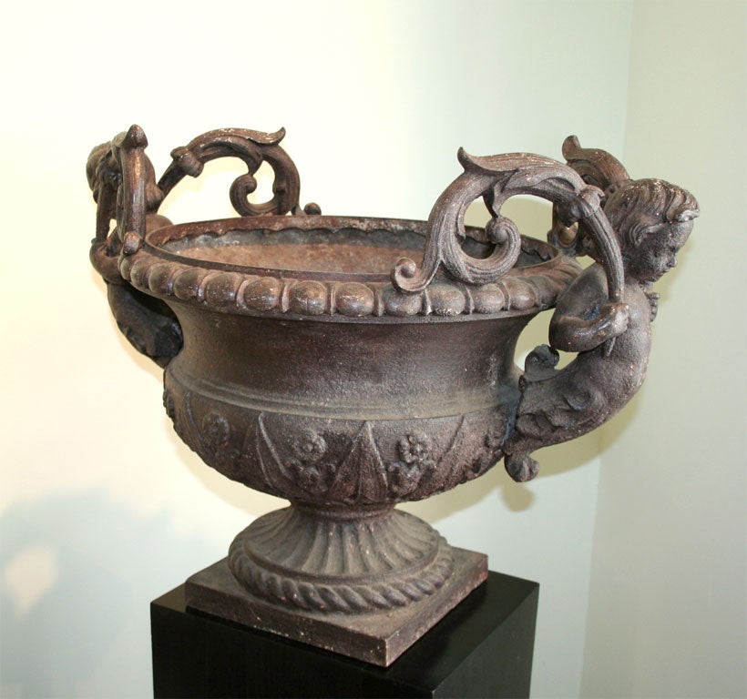 Magnificent pair of 19th century cherub planters. These cast iron beauties would bring romance and charm to any garden. These are the real thing.