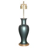A deep teal metallic finish pottery vase lamp
