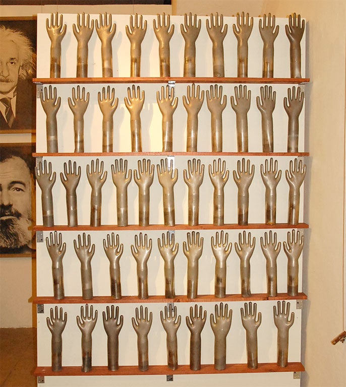 Collection of galvanised copper hands: glove moulds