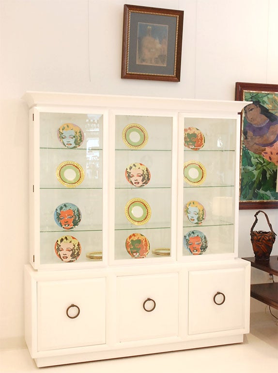 A Modern Originals two-part china cabinet designed by T.H. Robsjohn-Gibbings for Widdicomb Furniture.  The cabinet has bronze ring pulls and glass shelves, and is stamp dated from June of 1948.<br />
<br />
We have recently restored the cabinet in