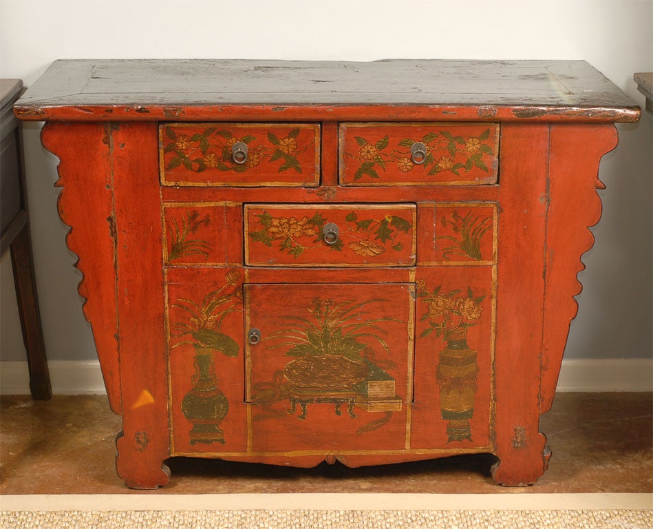 19th Century Asian Three Drawer, One Door Gansu Painted Cabinet in red floral decoration with a painted black top.  Retail price: $3,400.00 We are clearing a warehouse and are marking many pieces to sell quickly. This piece would make a wonderful