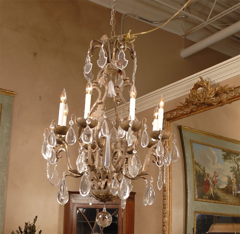 Beautiful wrought iron chandelier with eight lights and Czechoslovakian crystals.