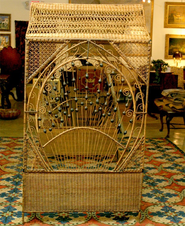 A Fine wicker canope bed with various decorations throughout