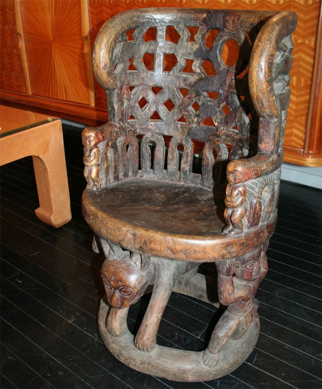 Hand-carved accent chair with animal, human and geometric motifs, Africa 1970’s.  This chair was sold through the Karl Springer showroom in NYC.