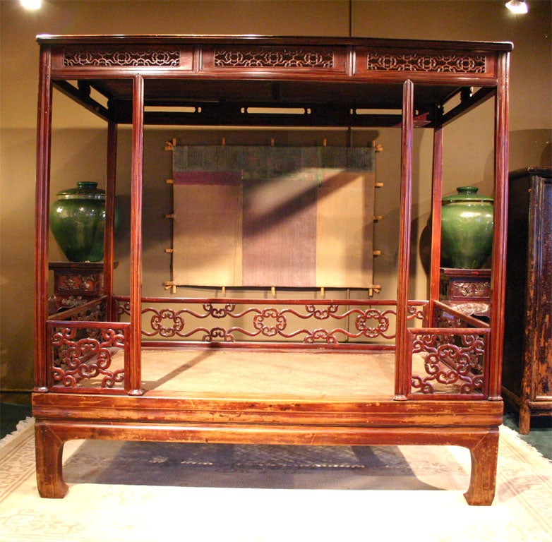 Carved Southern Chinese elm wood canopy daybed with horsehoof leg.