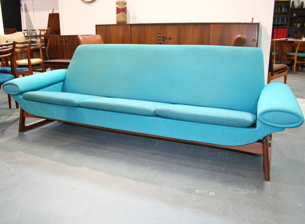 Fantastic sofa by Johannes Andersen reminiscent of the Atomic Era design style.  The seat cushions are offset by a houndstooth patterned fabric.  The legs are rails of solid teak.  Seat height is 14.5 inches.