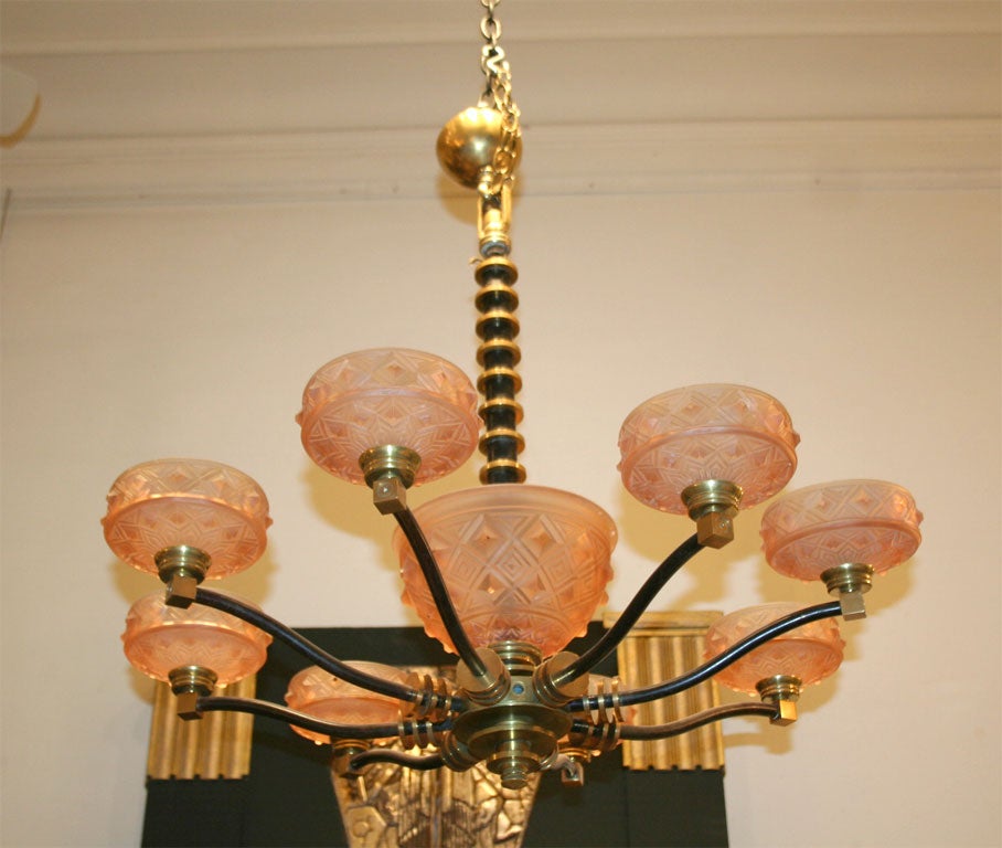 An eight light chandelier by  Edgar Brandt