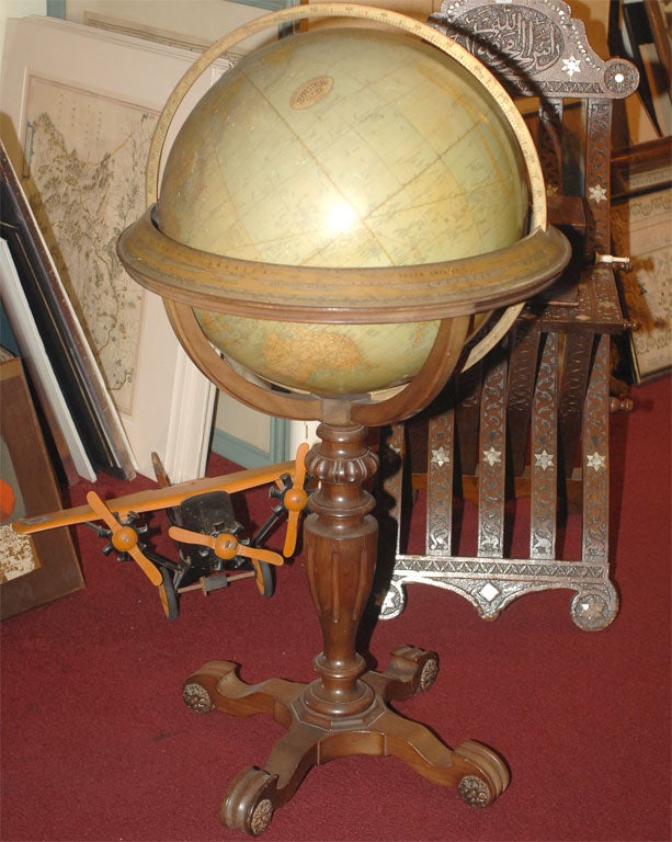 Classical Georgian-style terrestrial globe on original mahogany stand.