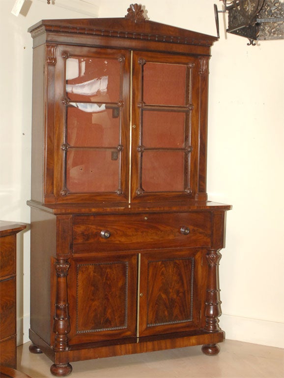 A beautiful William IV Period mahogany secretary bookcase made in England circa 1835. Great architectural pediment. Original glass. Well figured veneers and wonderful turned and carved columns. The secretary drawer is nicely fitted. Less than 2% of