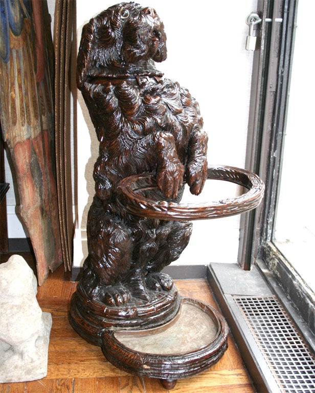 Black Forest Carved Fruitwood Umbrella or Stick Stand in the Form of a Dog, Late 19th Century <br />
<br />
15 inches wide x 21 inches deep x 34 inches high