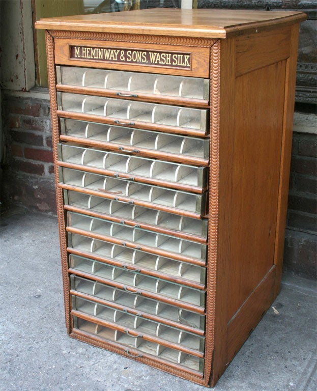 A rare antique oak 12 drawer Heminway & Sons fitted spool cabinet.