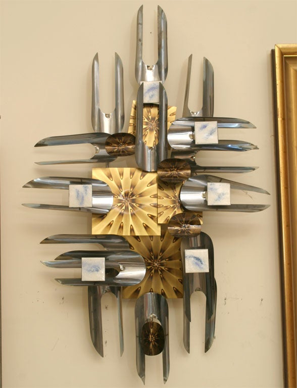 A magical and illusionary wall sculpture made with various types of metal and enamel.