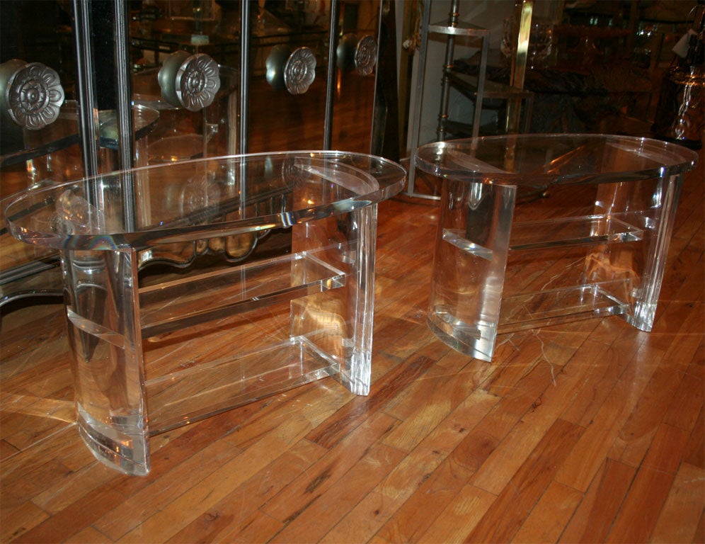 Pair of oval lucite side tables