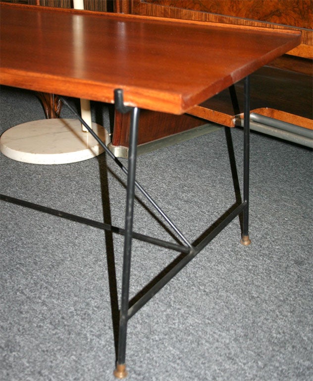 Cocktail table made in 1952 in Milan by Saporiti Italia. Top in mahogany with a one inch lip on each side on a black iron four base. Unusual, rare form.
 