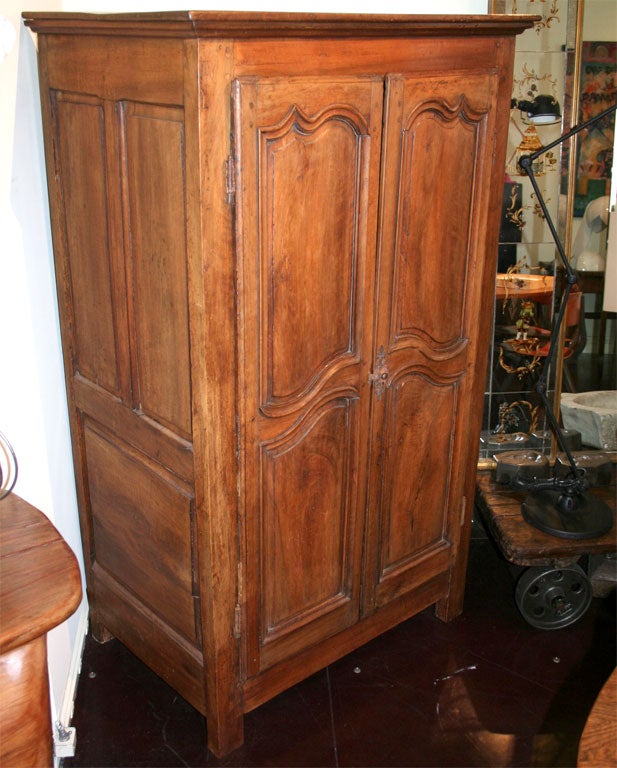 Very rare walnut two-door armoire. The 5 foot high size make this the perfect armoire for storage in a tight space.