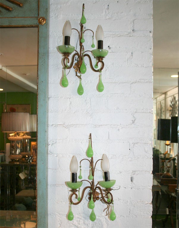 Elegant pair of green Opaline crystal teardrop sconces with brass detail and newly rewired.