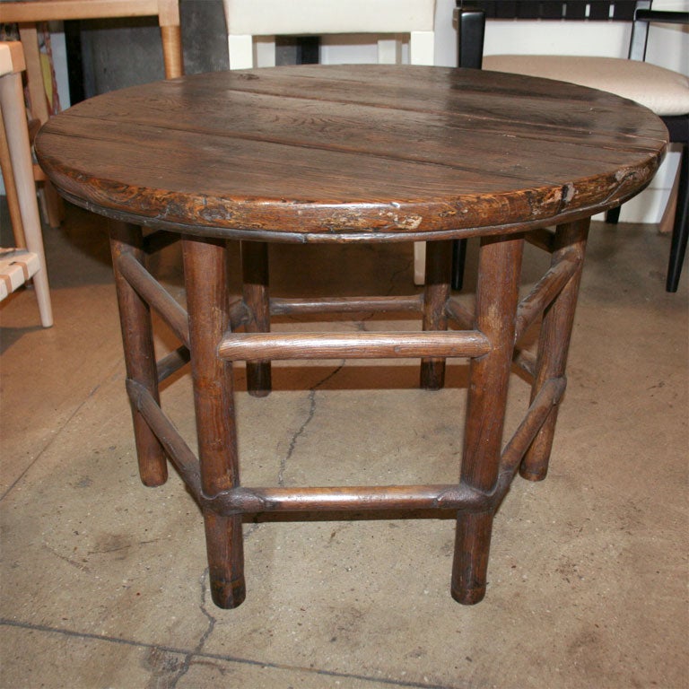 A low round table with Hexagonal base stretcher in walnut